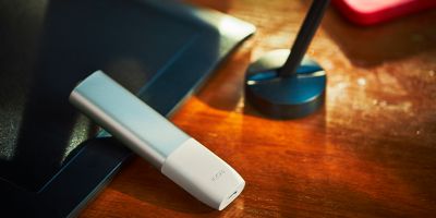 Folded hands in front a laptop.