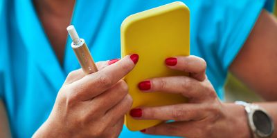 Folded hands in front a laptop.