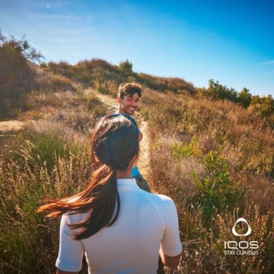 A pair of friends walking on a trail