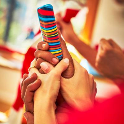 Ruce držící zařízení IQOS ILUMA WE PRIME z limitované edice.