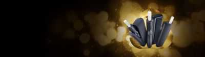 IQOS ILUMA i Geräte auf einem goldenen, festlichen Hintergrund