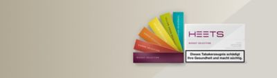 Aufgefächerte HEETS Tabacksticks und HEETS Russet Selection stehend auf einem beigefarbenen Hintergund abgebildet.
