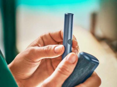 An Azure Blue IQOS ILUMA PRIME Holder and Pocket Charger.