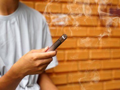 Person using a disposable vape device