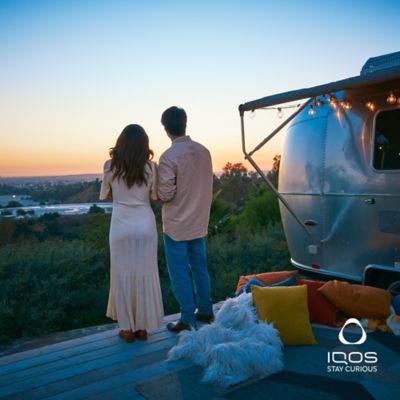 A couple camping together and looking over the horizon