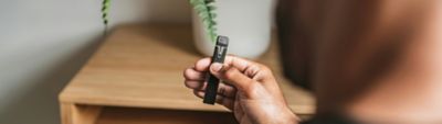 Black vape pen with a transparent pod