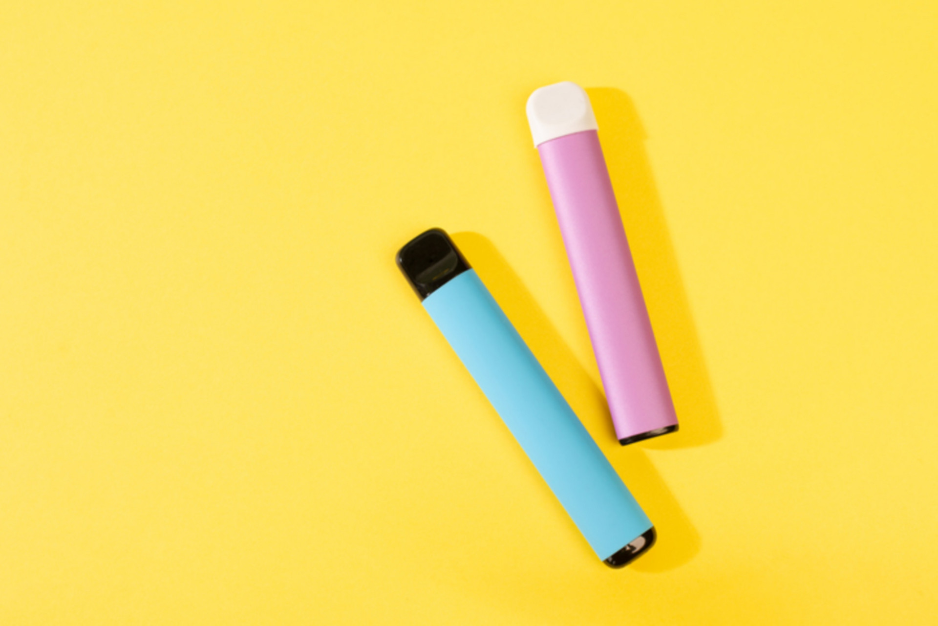 Disposable electronic cigarettes with shadow on a yellow background