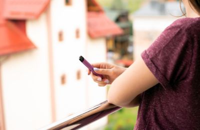 Woman holding disposable vape device