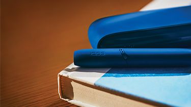 Gold IQOS DUO on a laptop