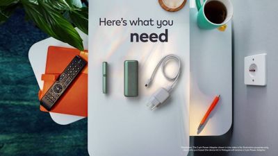 A charging cable being inserted into an IQOS ILUMA PRIME holder.