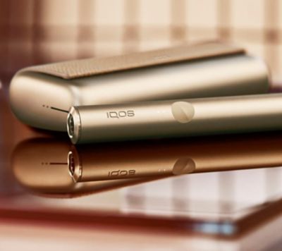 A person places a TEREA stick into an IQOS ILUMA PRIME Holder.