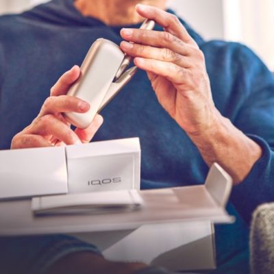 Man unboxing an IQOS 3 DUO