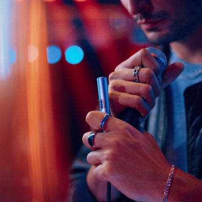 Hombre sosteniendo un IQOS ILUMA i PRIME color Breeze Blue en su mano