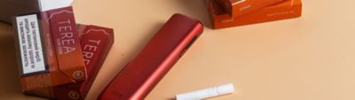 An IQOS ILUMA device with TEREA tobacco stick packs