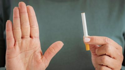 person pouring e-liquid into a vape