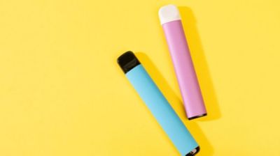 Disposable electronic cigarettes with shadow on a yellow background