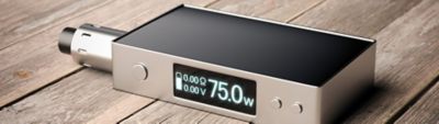 Rectangular vape mod device with a digital screen displaying 75W power output, placed on a wooden surface.