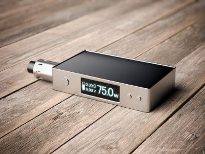 Rectangular vape mod device with a digital screen displaying 75W power output, placed on a wooden surface.