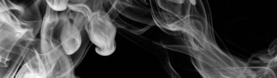 White smoke drifting against a black background