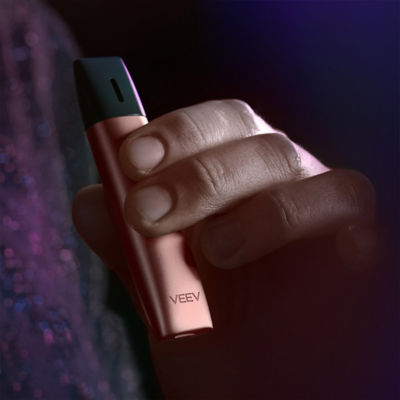 Brilliant gold IQOS 3 DUO and charger in hand