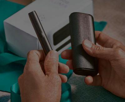 A man with an IQOS box.